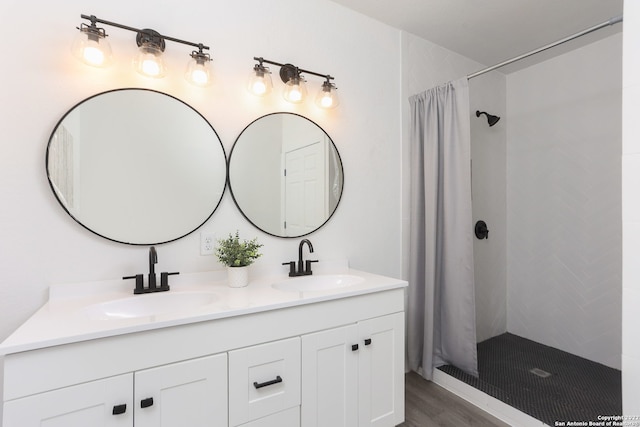 bathroom featuring vanity, walk in shower, and hardwood / wood-style floors