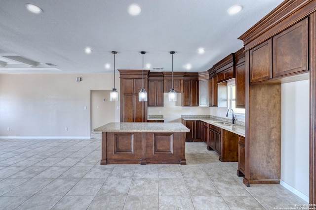 144 W Brazos St, Uvalde, TX 78801 - kitchen with a sink, a center island, baseboards, and recessed lighting