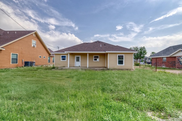 144 W Brazos St, Uvalde, TX 78801 - back of house featuring a yard, roof with shingles, and a patio area