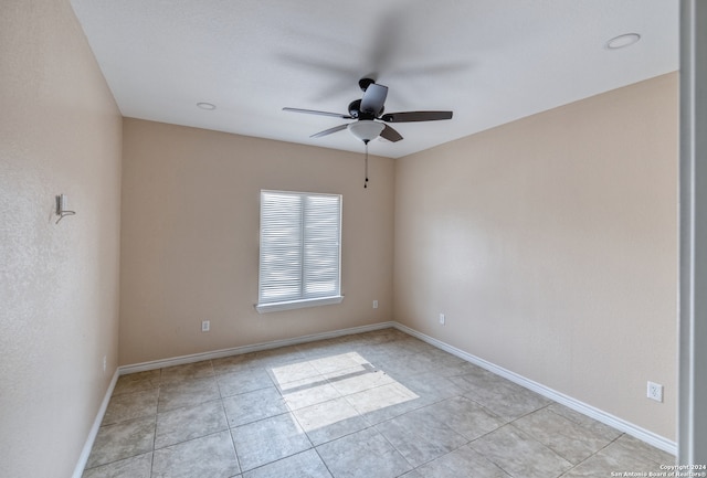 tiled empty room with ceiling fan