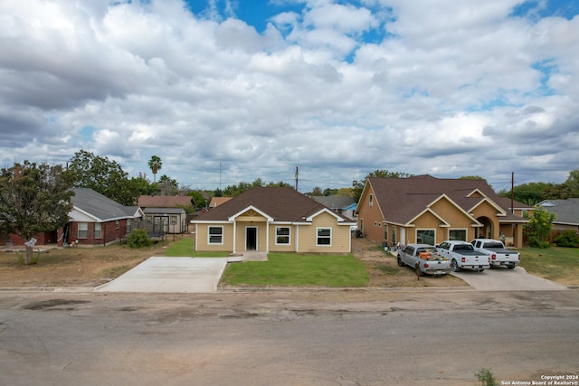 view of front of house with a front yard and a garage