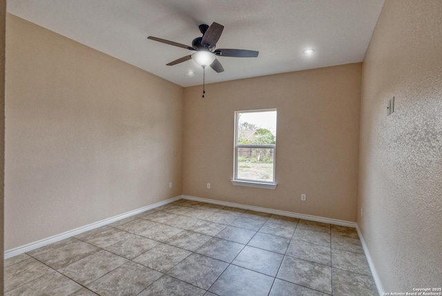 144 W Brazos St, Uvalde, TX 78801 - spare room featuring baseboards, ceiling fan, a textured wall, and light tile patterned floors