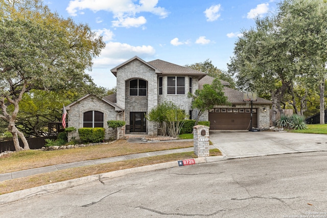 french country inspired facade featuring a front lawn and a garage