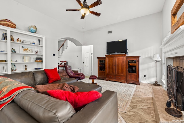 living room with a high ceiling and ceiling fan