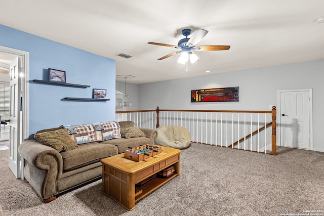 carpeted living room with ceiling fan