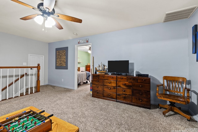 interior space featuring light colored carpet and ceiling fan