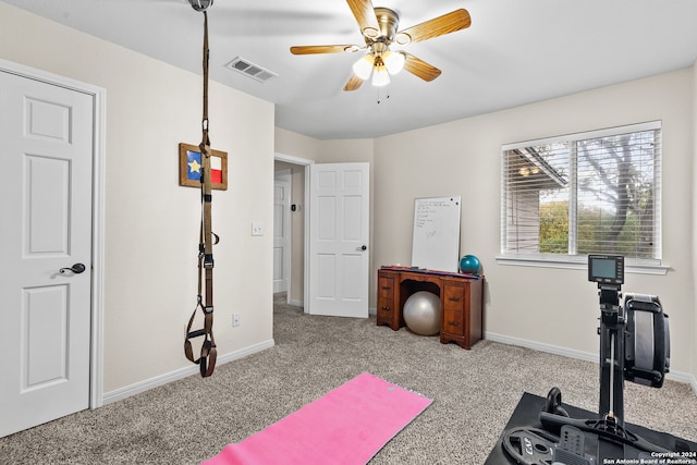 workout area with light carpet and ceiling fan