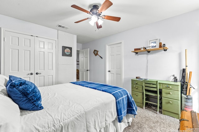 carpeted bedroom featuring a closet and ceiling fan