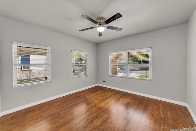 spare room with a textured ceiling, wood-type flooring, and ceiling fan