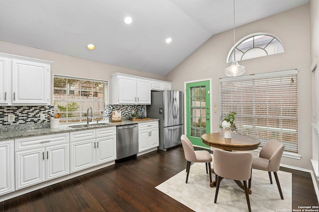 kitchen with sink, tasteful backsplash, white cabinetry, appliances with stainless steel finishes, and dark hardwood / wood-style flooring