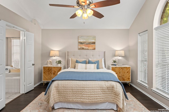 bedroom with ceiling fan, vaulted ceiling, and dark hardwood / wood-style flooring