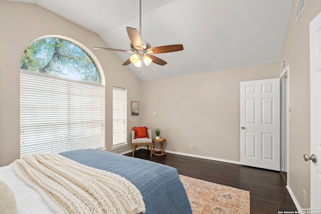 bedroom with dark wood-type flooring, vaulted ceiling, and ceiling fan