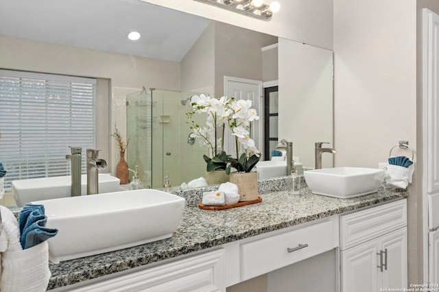 bathroom featuring vanity and an enclosed shower