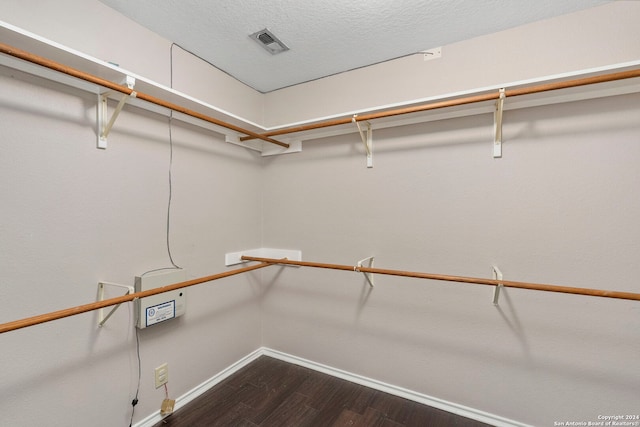 walk in closet featuring dark hardwood / wood-style flooring