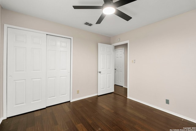 unfurnished bedroom featuring a closet, ceiling fan, and dark hardwood / wood-style flooring