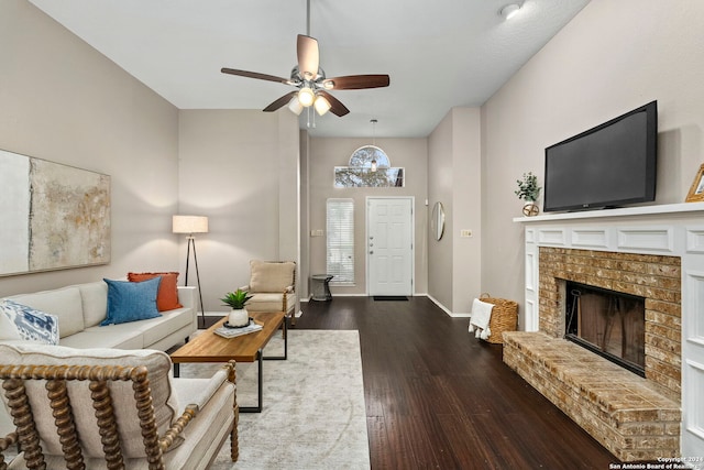 living room featuring hardwood / wood-style floors, ceiling fan, and a brick fireplace