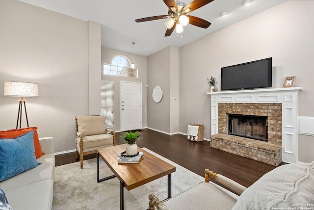 living room featuring hardwood / wood-style floors, a fireplace, and ceiling fan