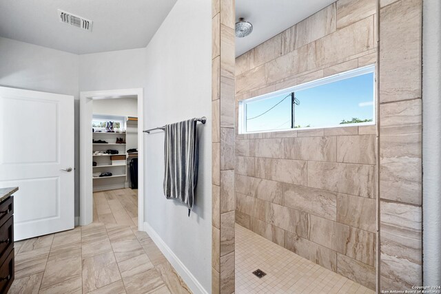 bathroom featuring vanity and a tile shower