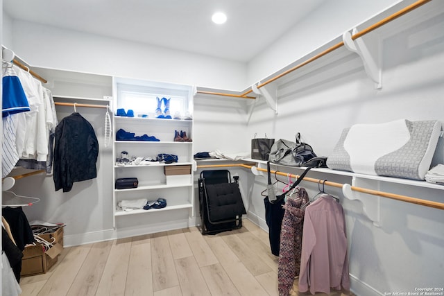 spacious closet with light hardwood / wood-style flooring