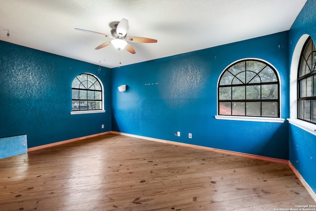 unfurnished room with wood-type flooring and ceiling fan