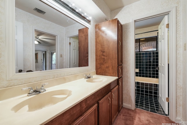 bathroom with tile patterned flooring, vanity, and ceiling fan