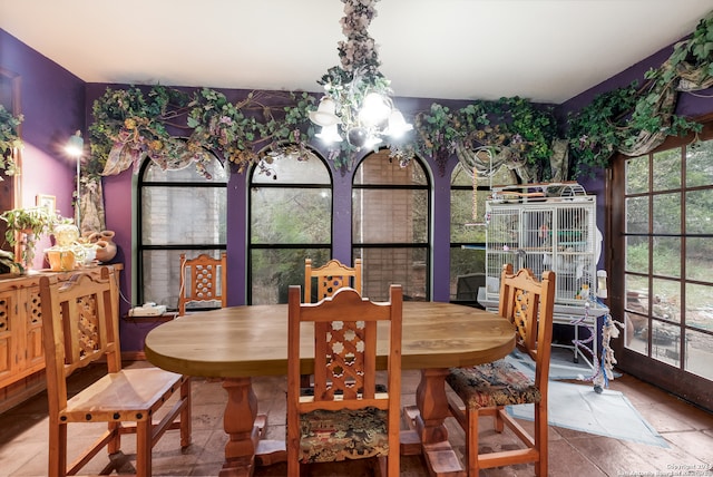 dining space with a healthy amount of sunlight and an inviting chandelier