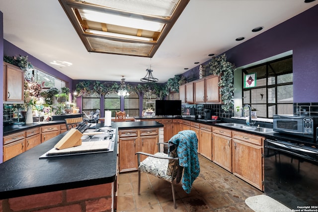 kitchen featuring sink, a center island, decorative light fixtures, dishwasher, and backsplash