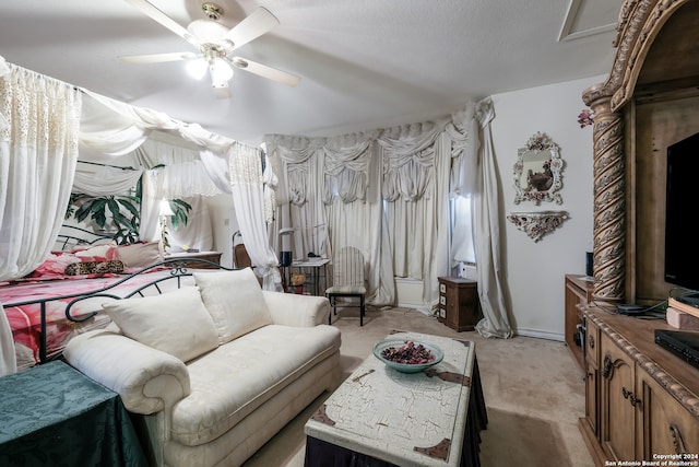 bedroom with a textured ceiling, light colored carpet, and ceiling fan