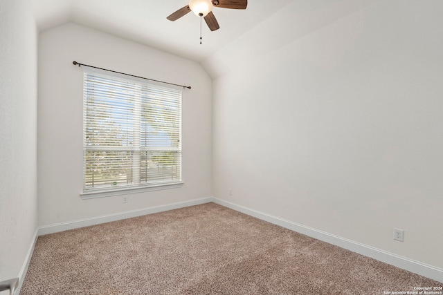 spare room featuring ceiling fan, vaulted ceiling, and carpet floors