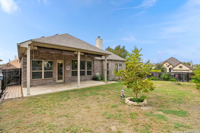 back of property with a patio and a lawn