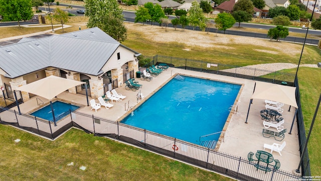 view of pool featuring a patio and a lawn