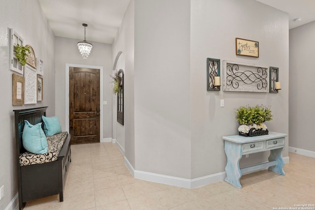 entrance foyer with a notable chandelier and light tile patterned floors