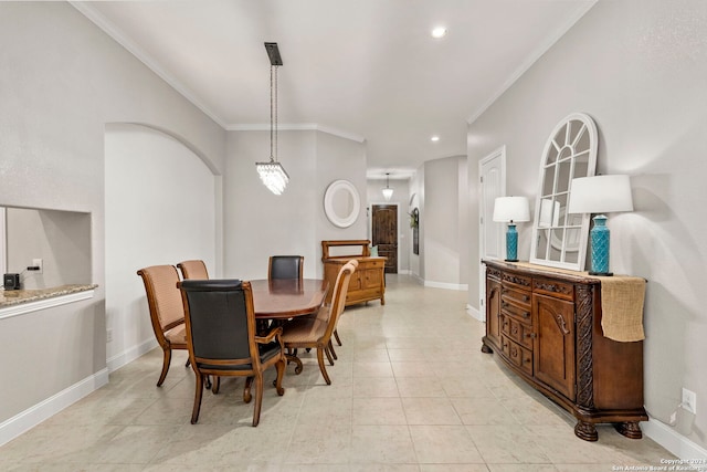 dining room featuring ornamental molding and light tile patterned floors