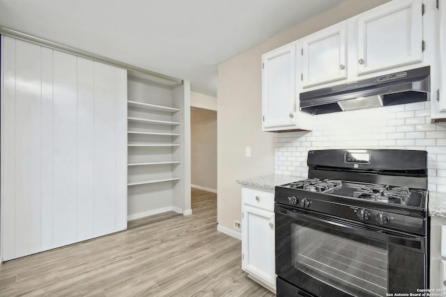 kitchen featuring white cabinets, gas stove, light hardwood / wood-style floors, and tasteful backsplash