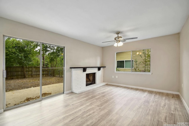 unfurnished living room featuring light hardwood / wood-style flooring, a fireplace, and ceiling fan