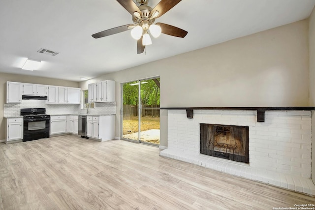 kitchen with light wood-type flooring, ceiling fan, black gas range, white cabinets, and decorative backsplash