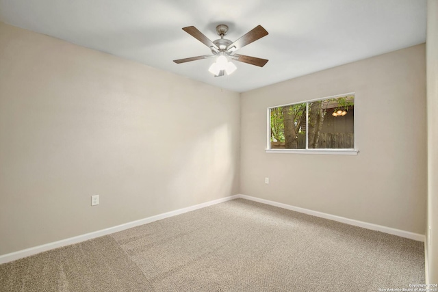 unfurnished room with ceiling fan and carpet