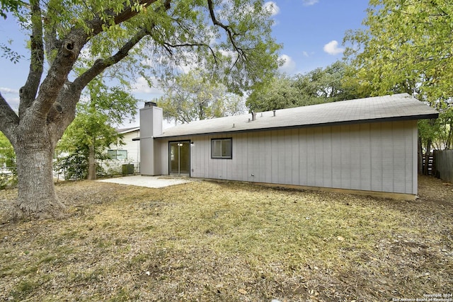 rear view of property with a yard and a patio