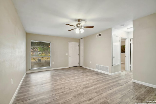 spare room featuring light hardwood / wood-style floors and ceiling fan