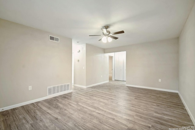 empty room with ceiling fan and light wood-type flooring