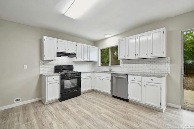 kitchen with plenty of natural light, white cabinets, stainless steel dishwasher, and black gas range oven