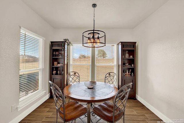 dining area featuring a chandelier and dark hardwood / wood-style floors