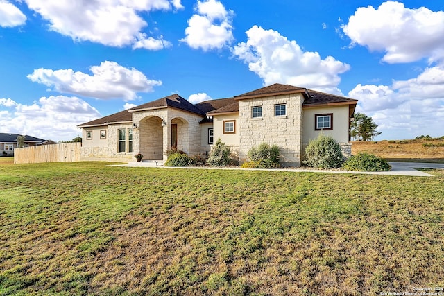 mediterranean / spanish house featuring a front lawn