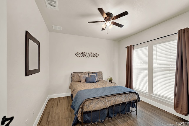 bedroom with ceiling fan and hardwood / wood-style floors