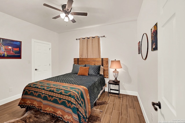 bedroom with ceiling fan and hardwood / wood-style floors