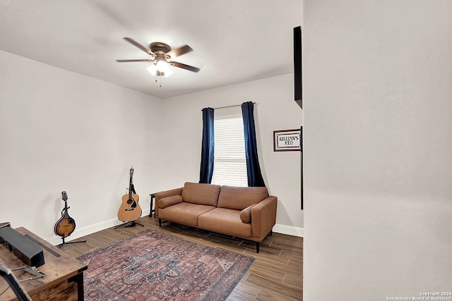 living room featuring light hardwood / wood-style flooring and ceiling fan