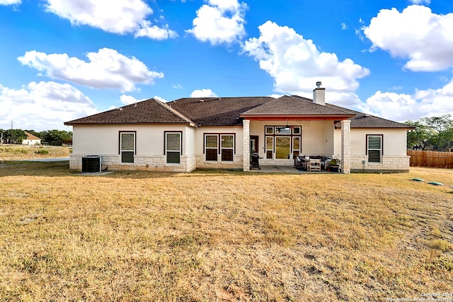 back of house with central AC, a yard, and a patio area