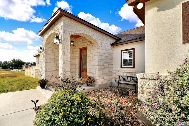 property entrance with a yard