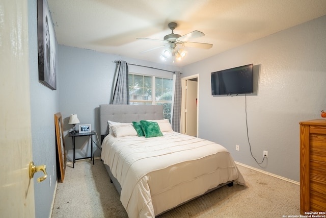 bedroom with light colored carpet and ceiling fan