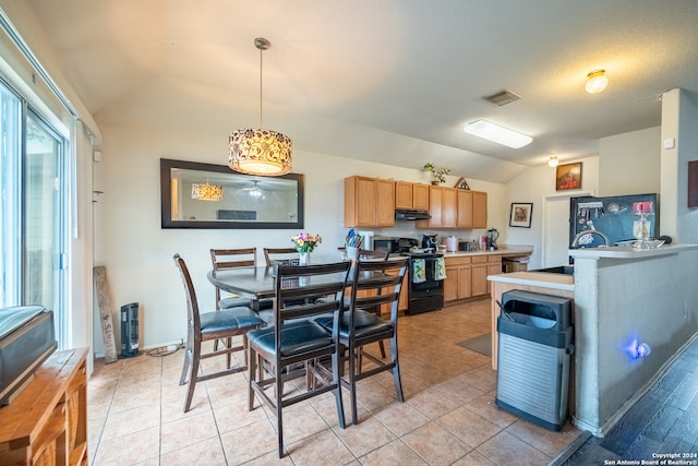 dining space featuring lofted ceiling, sink, light tile patterned floors, and a textured ceiling